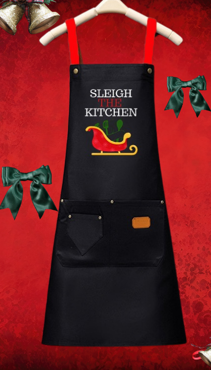 Black apron with 'Sleigh Kitchen' text and Santa's sleigh graphic on a red background.